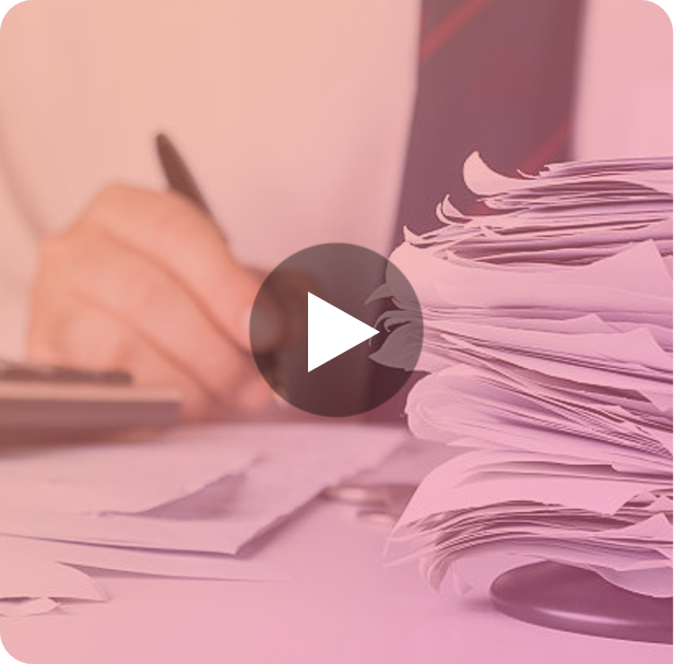 A group of people sitting around a table working on a laptop.